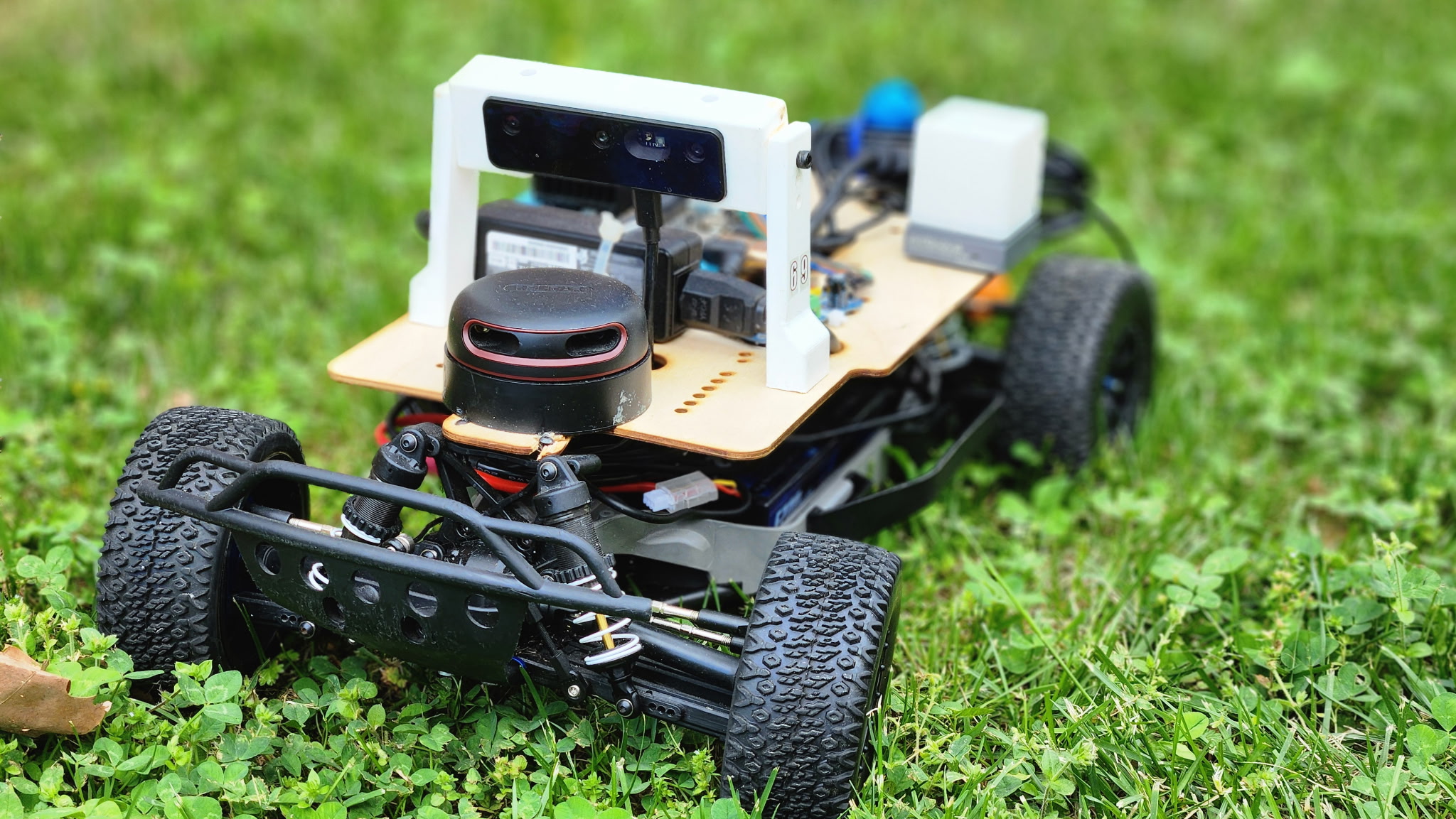 Atlas Autoware's self-driving car — a sensor rig with LiDAR and a depth camera mounted on an RC chassis